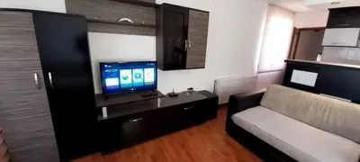 a living room with a couch and a flat screen tv at Apartman Ivanovic 4 in Soko Banja