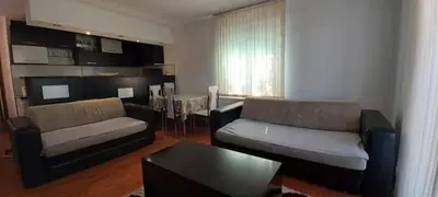 a living room with a couch and a table in it at Apartman Ivanovic 4 in Soko Banja