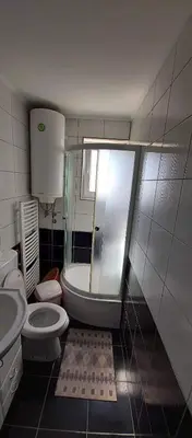 a bathroom with a shower and a toilet and a sink at Apartman Ivanovic 4 in Soko Banja