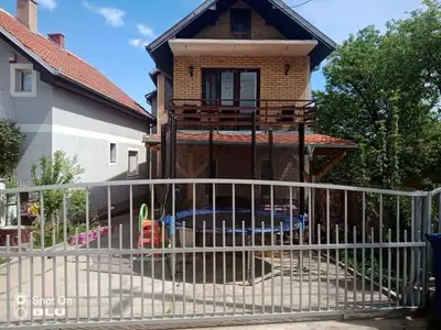 a white fence in front of a house at Apartman Ivanovic 4 in Soko Banja