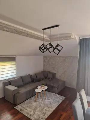 a living room with a couch and a table at Apartman In Lux in Vrnjačka Banja