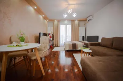 a living room with a couch and a table at Apartman In Lux in Vrnjačka Banja