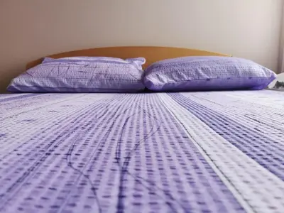 a purple bed with two purple pillows on it at Jumiko Apartments in Vrnjačka Banja
