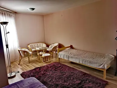 a bedroom with a bed and a table and chairs at Jumiko Apartments in Vrnjačka Banja
