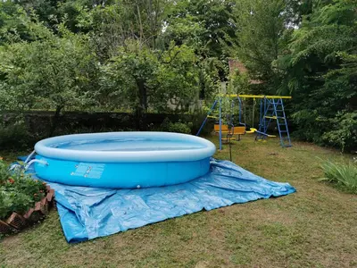 a large blue tub on a tarp next to a playground at Jumiko Apartments in Vrnjačka Banja