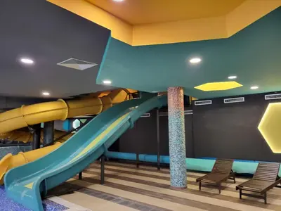 a slide in a play room with chairs at JORDAN Apartment KC 9C 35 Kopaonik in Kopaonik