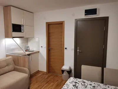 a small apartment with a couch and a kitchen at JORDAN Apartment KC 9C 35 Kopaonik in Kopaonik