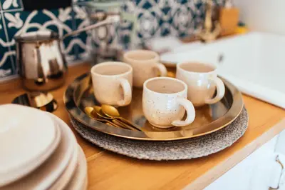 a tray with cups and spoons on a table at Armadillo Houses in Kopaonik