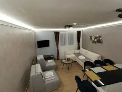 a living room with a couch and a table at Suncana planina apartman 103 in Kopaonik