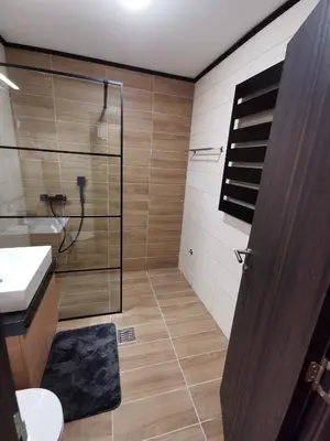 a bathroom with a shower and a toilet and a sink at Suncana planina apartman 103 in Kopaonik