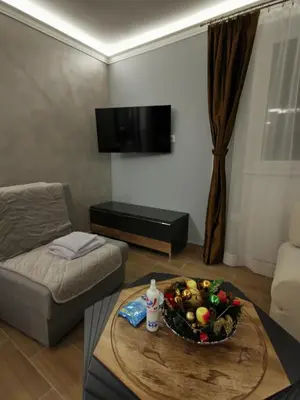 a living room with a bowl of fruit on a table at Suncana planina apartman 103 in Kopaonik