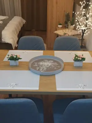 a table with blue chairs and a plate on it at President KOP A515 in Kopaonik