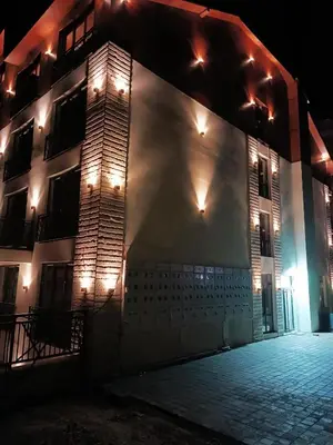 a building with lights on the side of it at night at President KOP A515 in Kopaonik