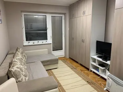 a living room with a couch and a television at Apartman Djuric Paracin in Paraćin
