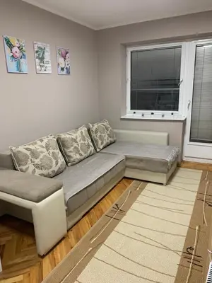 a living room with a couch and a window at Apartman Djuric Paracin in Paraćin