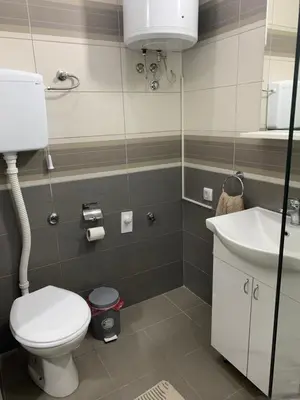 a bathroom with a toilet and a sink at Apartman Djuric Paracin in Paraćin
