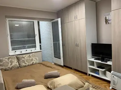 a living room with a couch and a flat screen tv at Apartman Djuric Paracin in Paraćin