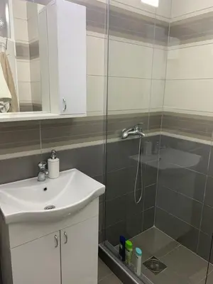a bathroom with a shower and a sink and a shower at Apartman Djuric Paracin in Paraćin