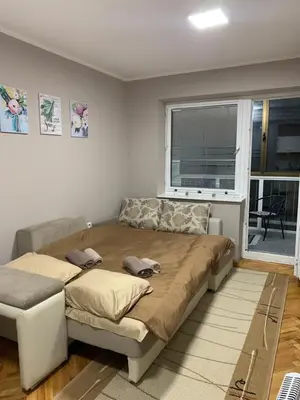 a large bed in a room with a window at Apartman Djuric Paracin in Paraćin