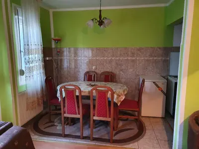 a table and chairs in a kitchen with green walls at Smestaj Boki in Soko Banja