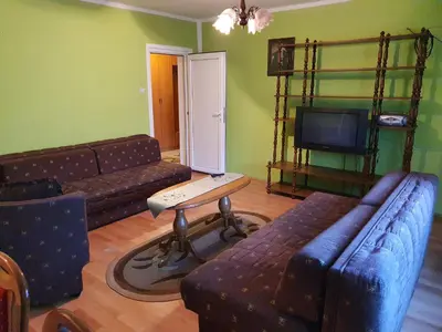 a living room with a couch and a table and a tv at Smestaj Boki in Soko Banja