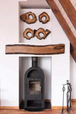 a room with a fireplace with pretzels on the wall at Vista Mountain House in Kopaonik