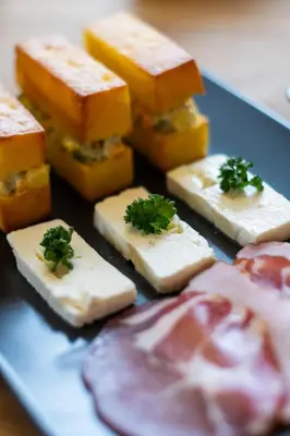 a plate of cheese and other foods on a table at Vista Mountain House in Kopaonik