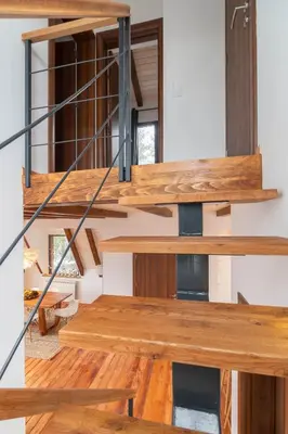 a wooden staircase in a house with wooden floors at Vista Mountain House in Kopaonik