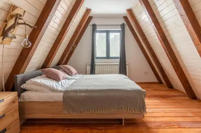 a bedroom with a bed in a attic at Vista Mountain House in Kopaonik