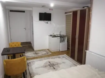 a small room with a table and a room with a bed at ORTODOKS in Brus