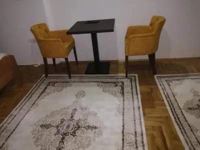 a room with two chairs and a table and two rugs at ORTODOKS in Brus