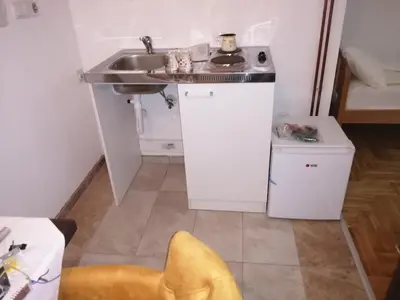 a small kitchen with a sink and a counter at ORTODOKS in Brus