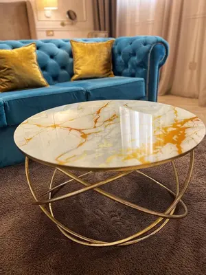 a coffee table in front of a blue couch at Dis Delux in Kruševac