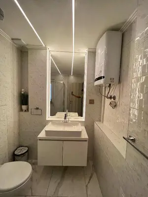 a bathroom with a sink and a toilet and a mirror at Dis Delux in Kruševac