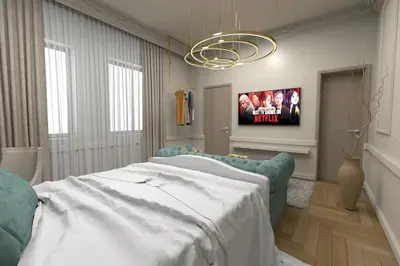 a bedroom with a bed and a tv on a wall at Dis Delux in Kruševac