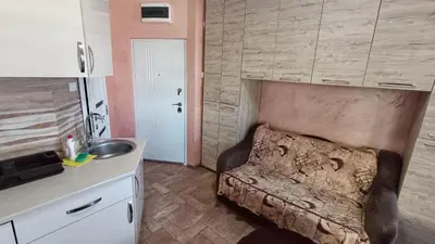 a living room with a couch in a kitchen at Vila Plan Karaman greben in Raška