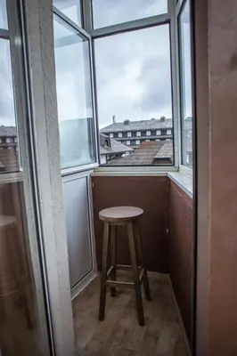a stool sitting in front of a window at Vila Plan Karaman greben in Raška