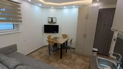 a living room with a table and a couch at Vila Plan Karaman greben in Raška