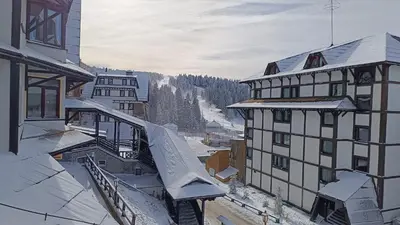 a view of a snowy mountain from a building at Vila Plan Karaman greben in Raška