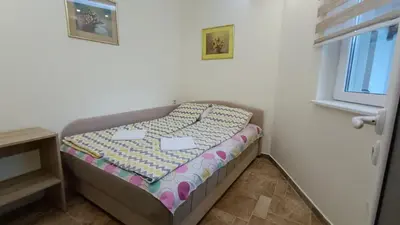 a small bed in a corner of a room at Vila Plan Karaman greben in Raška