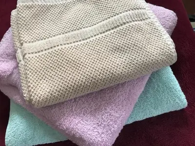 a pile of towels sitting on a table at Studio-Apartman Dream018 in Brzeće