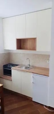 a kitchen with white cabinets and a sink at Studio-Apartman Dream018 in Brzeće