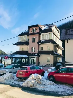 two cars parked in a parking lot in front of a building at Studio-Apartman Dream018 in Brzeće