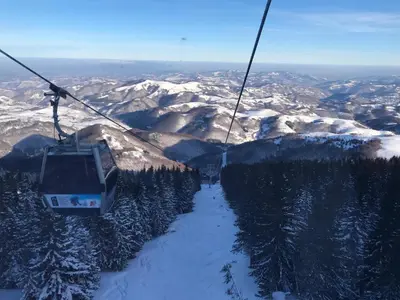 a ski lift going up a snow covered mountain at Studio-Apartman Dream018 in Brzeće