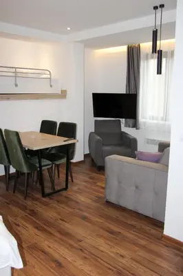 a living room with a table and a couch at Apartmani Sorak Kopaonik, Studio Apartman A10 in Kopaonik