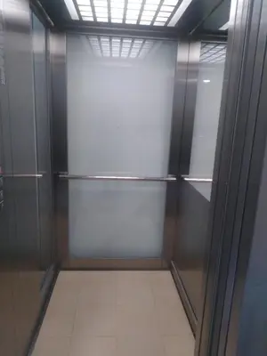 a walk in closet with metal doors and a tile floor at Apartman Mihajlovic in Soko Banja