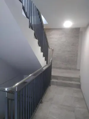 a staircase in a building with a stone wall at Apartman Mihajlovic in Soko Banja