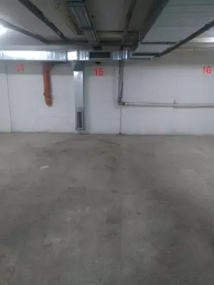 an empty parking garage with red numbers on the walls at Apartman Mihajlovic in Soko Banja