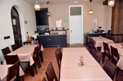 a restaurant with tables and chairs and a kitchen at Villa Mramor in Brzeće