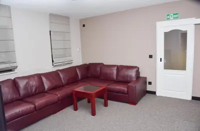 a living room with a brown leather couch and a table at Villa Mramor in Brzeće